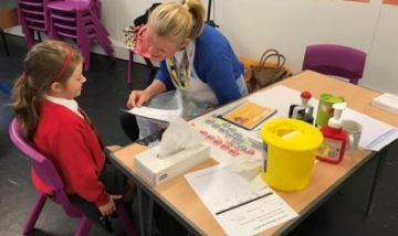 Child receiving the nasal flu vaccine