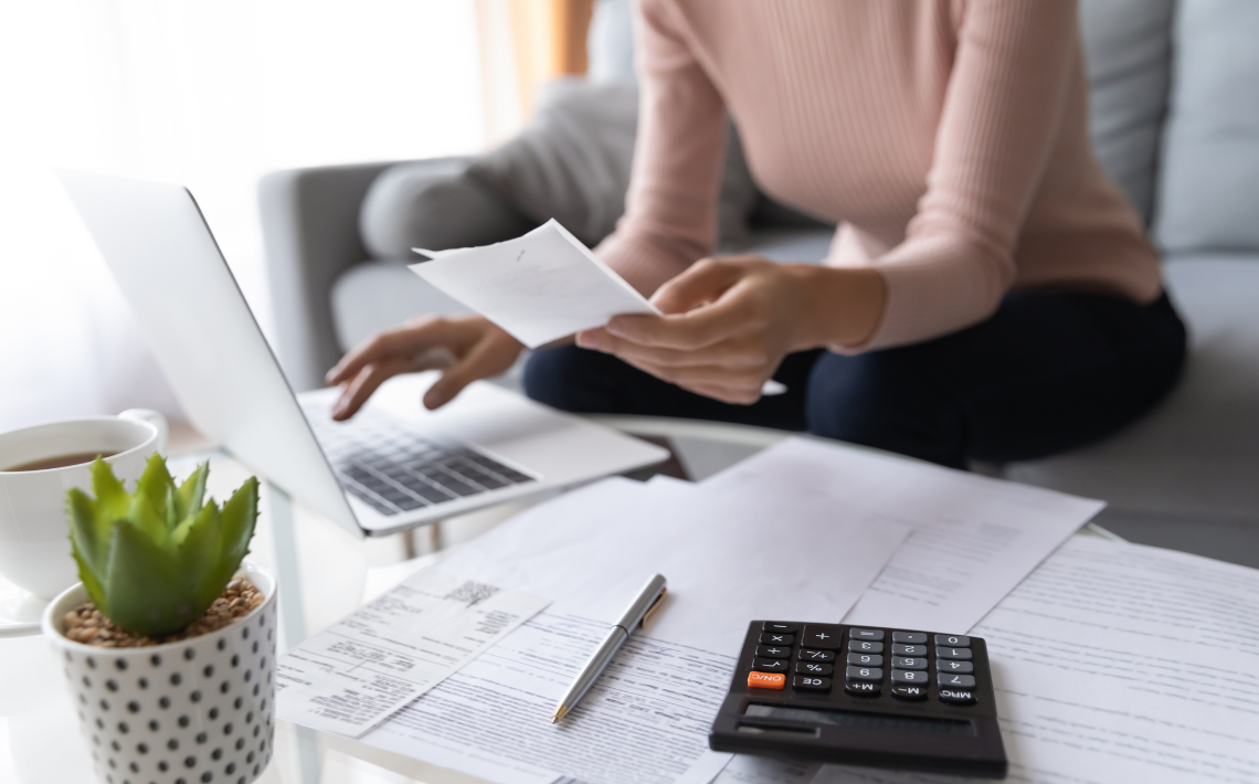 Adult on laptop working out finances