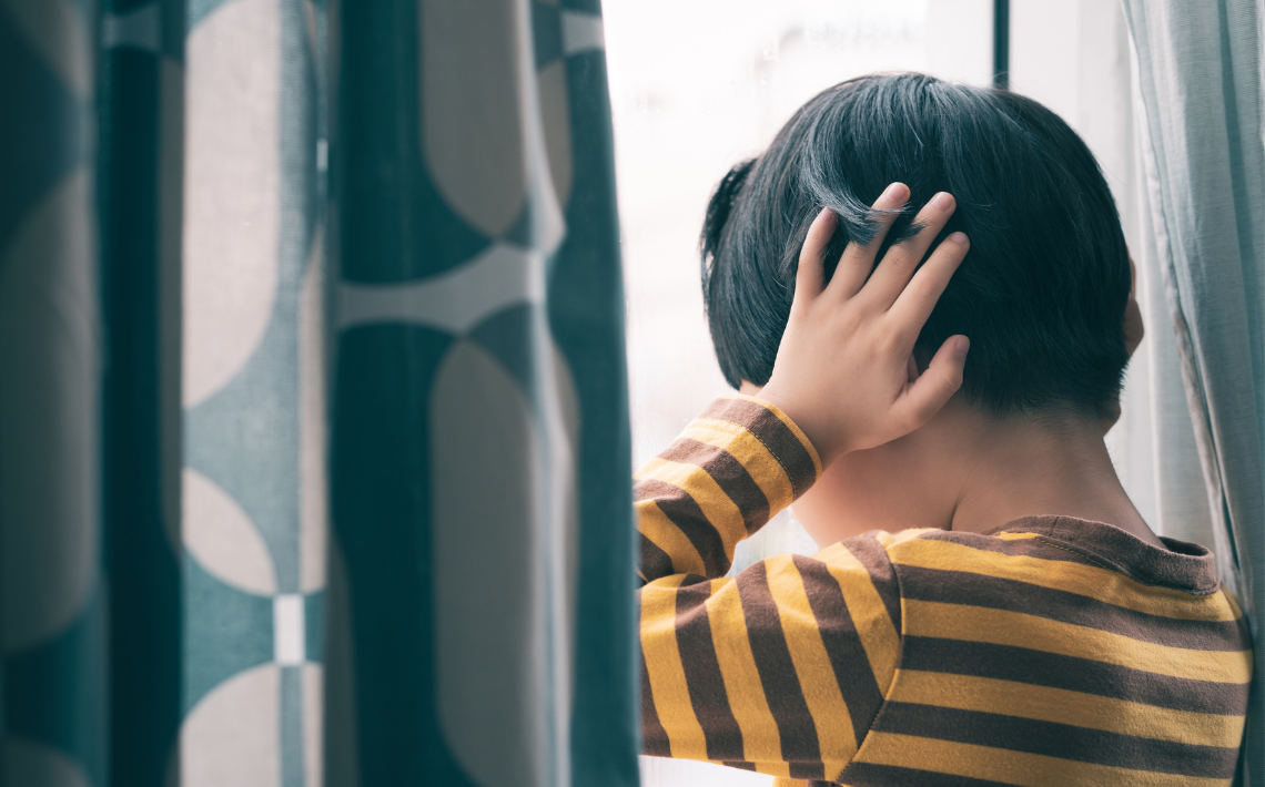 Child with hands over ears