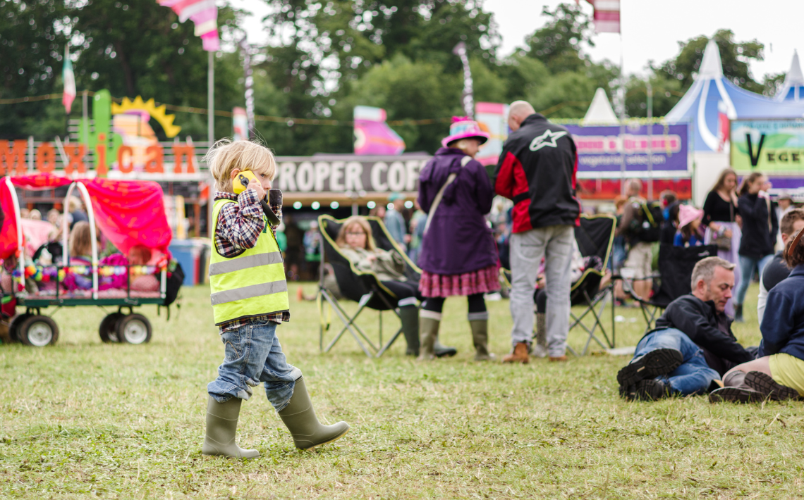 Child wearing ear defenders at festival