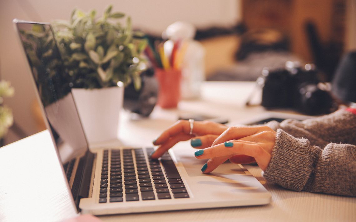 woman typing on laptop