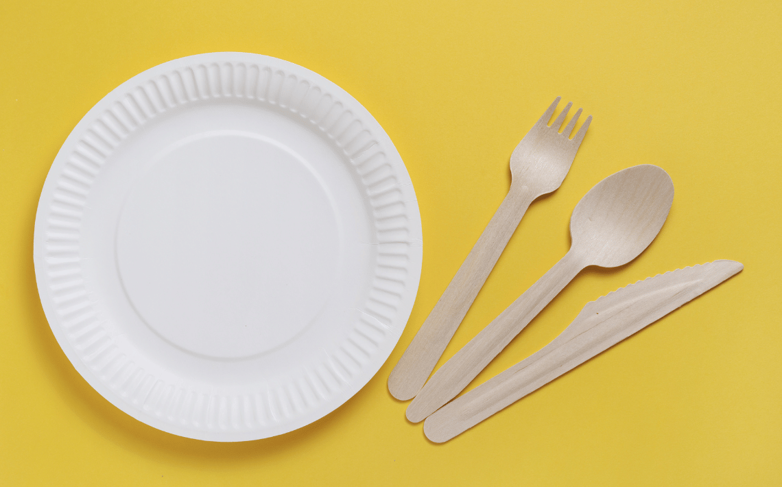 paper plate and cutlery on yellow background