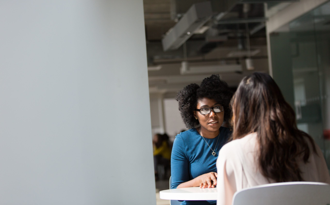 Women talking together at table