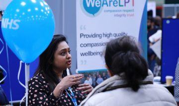 A health professional giving advice at a jobs and careers event