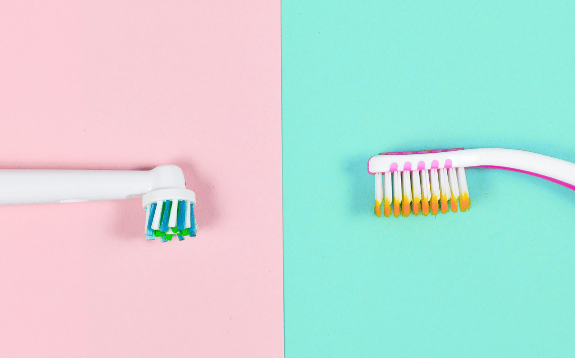Picture of two toothbrushes with pink and teal backgrounds