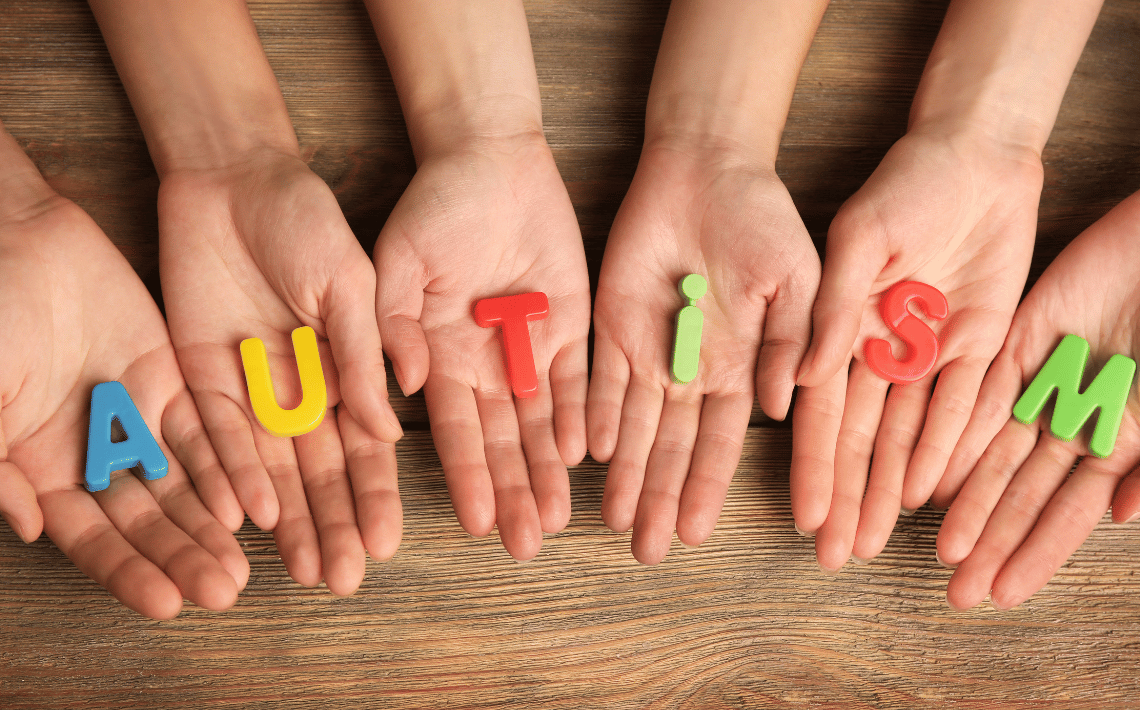 hands holding letters spelling the word autism