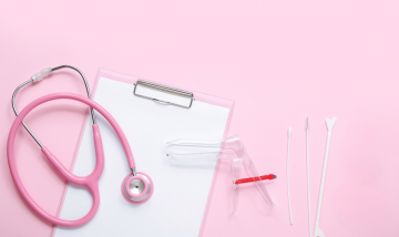 pink background with pink stethoscope, speculum and swabs