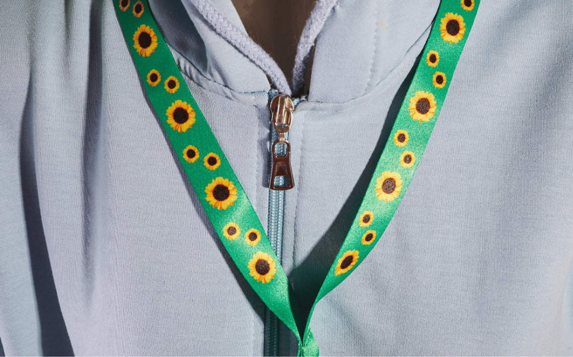 person wearing sunflower lanyard with grey top