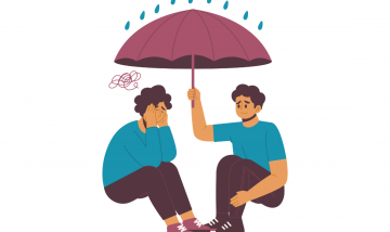 person holding umbrella over another person to protect them