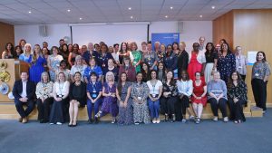 A group of around 70  people smiling at the camera at the Long Service Awards