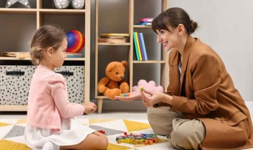 Assessor playing with a child during autism assessment
