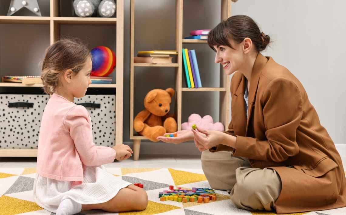 Assessor playing with a child during autism assessment
