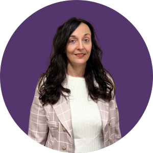 Angela Hillery smiling against a purple background.