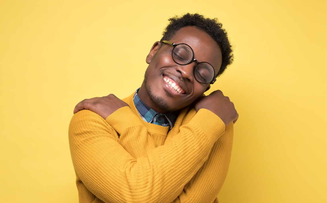 Man hugging himself for self love.