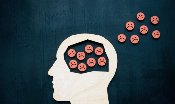 Side Profile of head with sad face icons