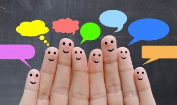 fingers with smiley faces and speech bubbles